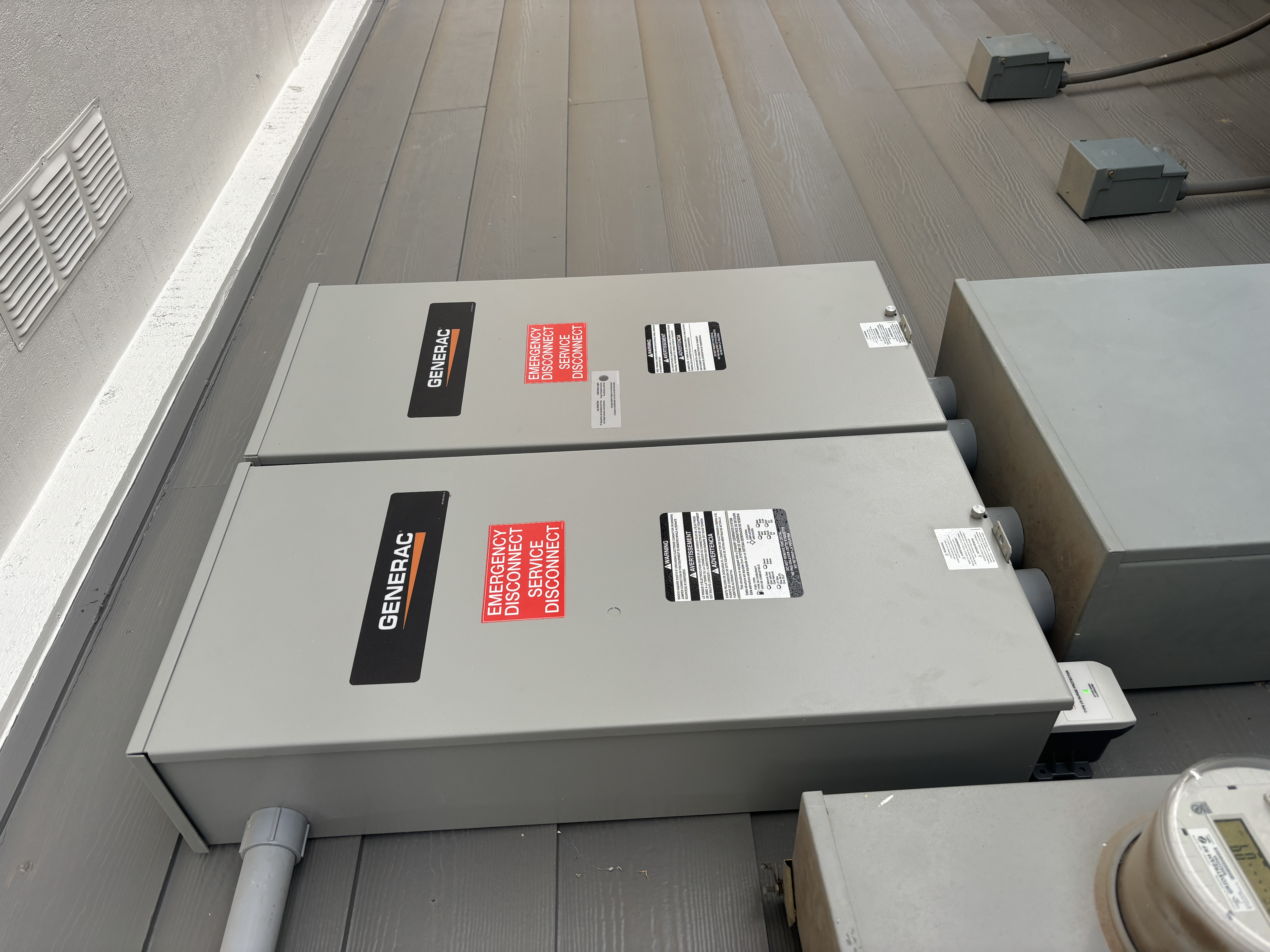 Installed Generac transfer equipment mounted beside a home